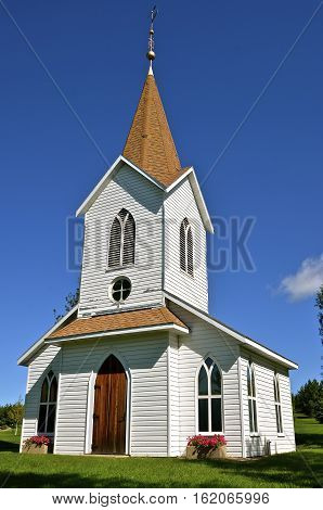 Beautiful rural white country church with a large belfry.