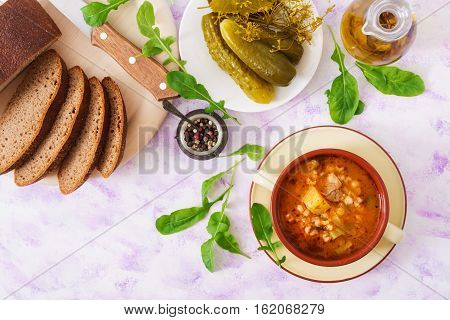 Soup With Pickled Cucumbers And Pearl Barley - Rassolnik On A Light Background. Top View. Flat Lay