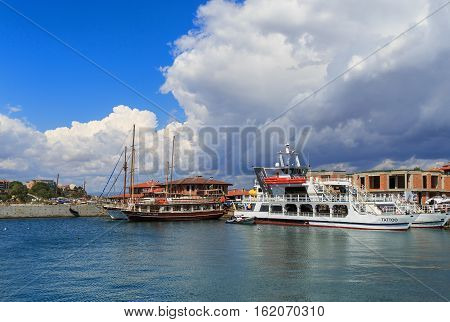 Nesebar Bulgaria - September 06 2013: Ships and boats in the port of the old town Nessebar on the bulgarian Black Sea coast. Sunny summer day. UNESCO world heritage site.