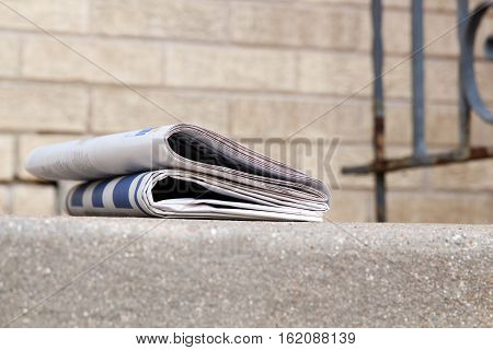 Pile of newspapers on a stairs, Building background behind