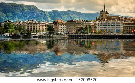 Geneve, Switzerland - 11 May 2014: panoramic view of the modern embankment and the center of Geneva with reflection in water, Switzerland