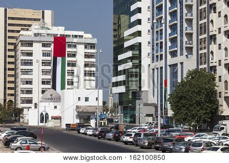 ABU DHABI UAE - NOV 24 2016: National flag of the United Arab Emirates on a building in the city of Abu Dhabi at the UAE National Day Celebrations