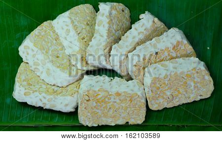 closeup soybean tempeh in banana leaves, food from indonesia