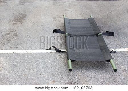 single light portable stretcher for medical evacuation or medevac for law enforcment tactical team isolated on road