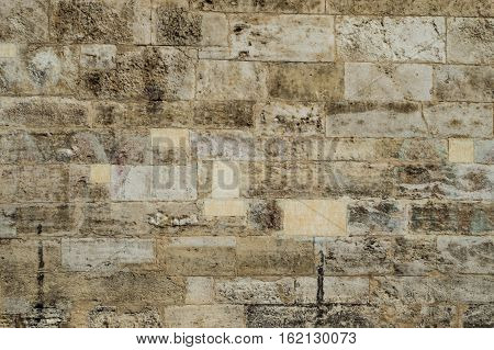 Old corroded running bond stone wall background