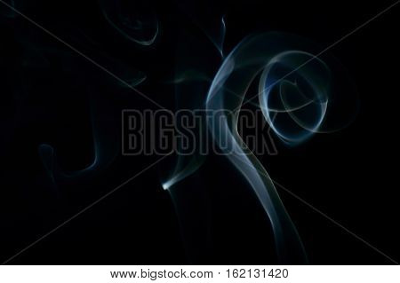 Curled up blue abstract moke art plume on a black background