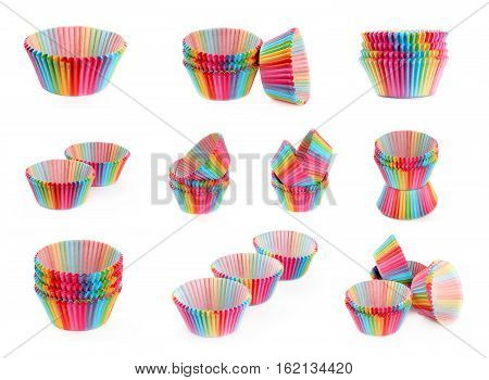 Set of colorful rainbow paper tins for baking cake muffin cupcake isolated on white background