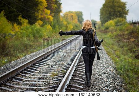 Girl With Arms On The Rails In Autumn Day