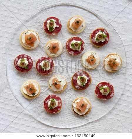 A plate of savoury pikelets in a glass dish.