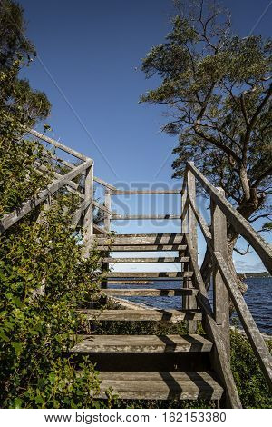 Wooden stair with scene view on Coalmine Beach Walpole Australia . vintage toning filter add .