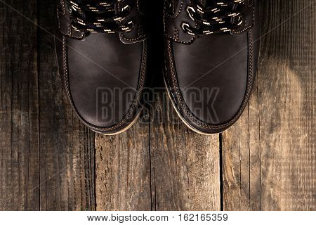 Brown genuine leather boots close up. Winter boots