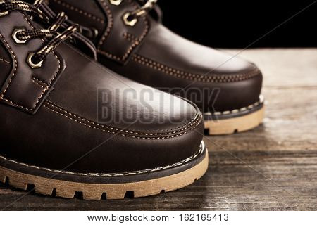 Brown genuine leather boots close up. Winter boots