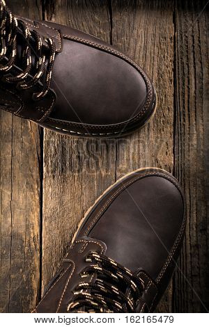 Brown genuine leather boots close up. Winter boots