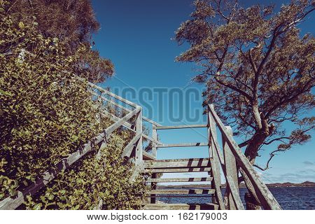 Wooden stair with scene view on Coalmine Beach Walpole Australia . vintage toning filter add .