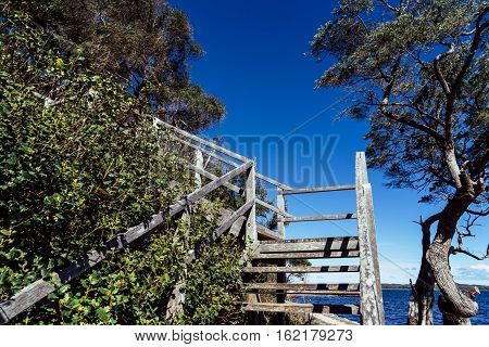 Wooden stair with scene view on Coalmine Beach Walpole Australia . vintage toning filter add .