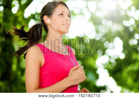 Young woman running at the park