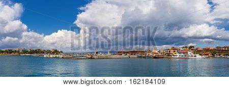 Nesebar Bulgaria - September 06 2013: Ships boats and yachts in the port of the old town Nessebar on the bulgarian Black Sea coast. UNESCO world heritage site. Panoramic shot.