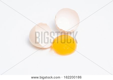 Eggs chicken bird with egg yolk and shell on a gray background