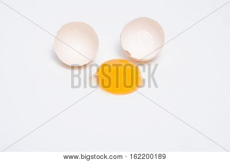 Eggs chicken bird with egg yolk and shell on a gray background