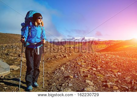 woman hiker on the trail in the Islandic mountains. woman standing and posing against the backdrop of a desert mountain landscape. Treking in National Park Landmannalaugar, Iceland. Travel photography concept