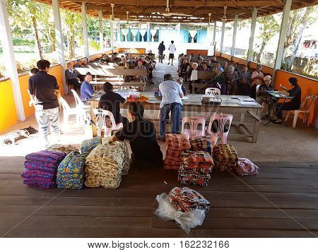 CHIANG RAI THAILAND - DECEMBER 19 : Unidentified asian officer preparing clothing for giving old people suffering from leprosy on December 19 2016 in Chiang rai Thailand.