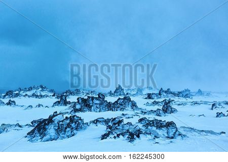 Lava field in a snow storm at twilight,  Snaefellsnes Peninsula, Iceland.