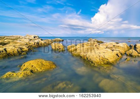 A view of beautiful Tanjung Kubong tropical beach with rocks formation located at the northern tip of Labuan Island. It is also the place where the famous and mysterious chimney standing high.