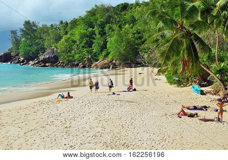 MAHE SEYCHELLES - JULY 06 2011: Tourists have a rest on the beautiful sandy beach Anse Soleil one from the most popular beaches at the island