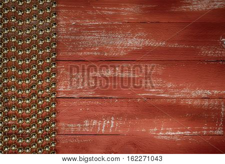 Orange wood background with a garland of golden balls empty space