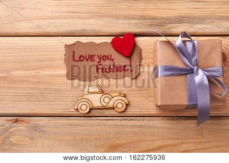 Love you father card. Pyrography car near gift box. Express your love through handmade.