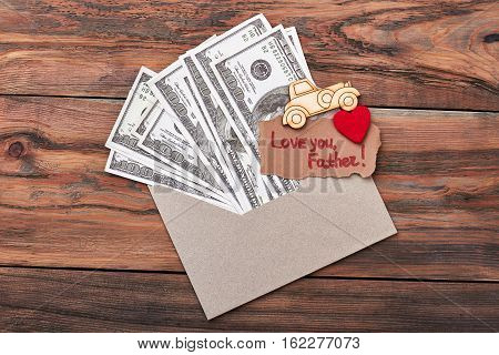 Pyrography car near money. Love you father greeting card. Make special present for dad.