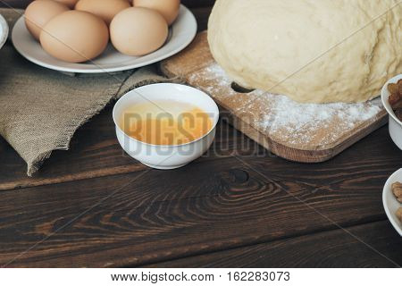wooden rustic kitchen board with organic ingredients for cooking cake. preparation for baking cake. culinary concept