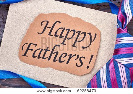 Happy Father's card and necktie. Greeting card and striped tie. Accessory for father's look.