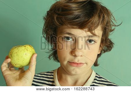 preteen handsome boy hold green apple close up potrtait