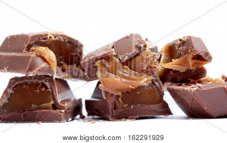 picture of a chopped chocolate piesec with caramel fill , macro, studio shot