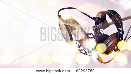 Studio Condenser Microphone And Equipment Behind A Glass