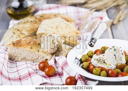 Italian focaccia bread with olives and basil