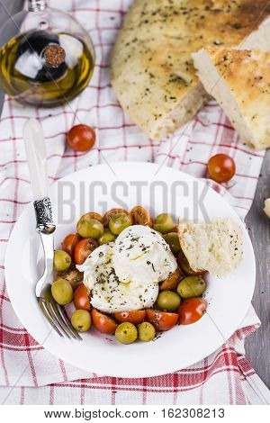 Italian focaccia bread with olives and basil