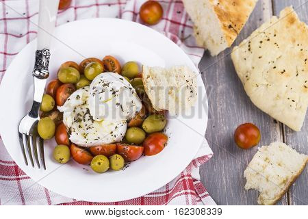 Italian focaccia bread with olives and basil