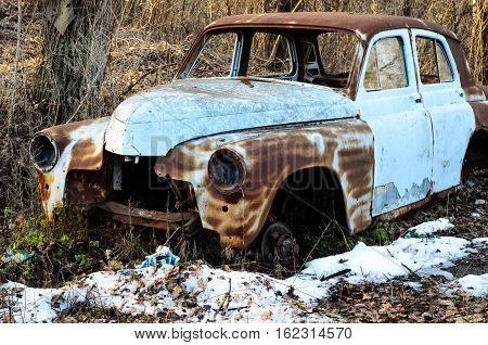 Old rusty car body on a ground