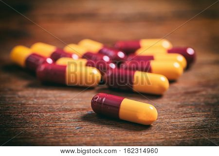 Colorful Capsules On A Wooden Background