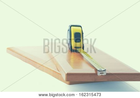 Wooden board and tools on a white background