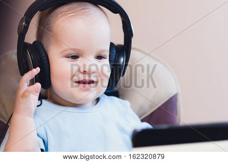 child listening to music on headphones at home