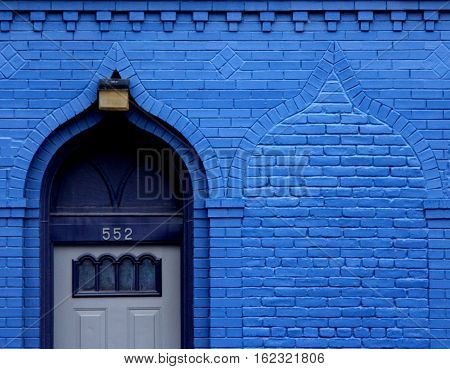 a bright blue doorway has a hidden twin