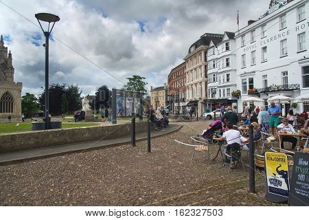 EXETER UK 11 July 2016: people sitting at the tables at an outdoor cafe on the square Cathedral Green. Exeter. Devon. UK