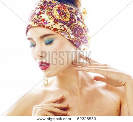 young pretty modern girl with bright shawl on head emotional posing isolated on white background, asian people ethnicity