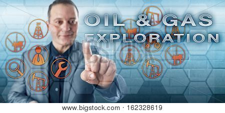 Happy industrial manager with toothless smile is pushing OIL & GAS EXPLORATION on a touch screen interface. Petroleum industry metaphor for both onshore and offshore search for hydrocarbon deposits.