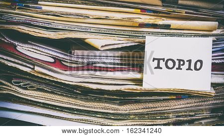 A Stack Of Old Newspapers, Words On A Paper Sticker