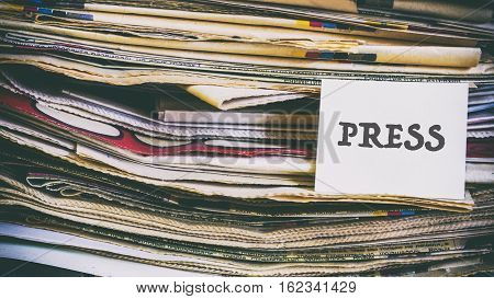 A Stack Of Old Newspapers, Words On A Paper Sticker