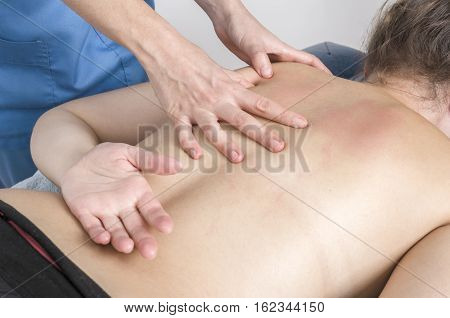 Physiotherapist, Chiropractor Giving A Massage And Stretching Of Subscapularis And Rhomboid